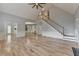 Open living room features hardwood floors, staircase, and access to other rooms in the house at 340 Kincardine Way, Alpharetta, GA 30022