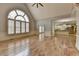Bright living room with large arched windows, hardwood floors, and open access to the kitchen at 340 Kincardine Way, Alpharetta, GA 30022