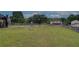 A spacious fenced backyard is perfect for outdoor activities, featuring lush grass and a basketball court at 102 Peaceful Vw, Acworth, GA 30102