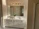 Bathroom featuring double sinks, large vanity, and bright lighting at 102 Peaceful Vw, Acworth, GA 30102