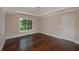 Bright bedroom with a tray ceiling, hardwood floors, and a large window at 102 Peaceful Vw, Acworth, GA 30102