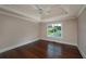 Bedroom featuring a tray ceiling, hardwood floors, and a view of the neighborhood at 102 Peaceful Vw, Acworth, GA 30102