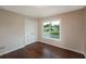 This bedroom features a double door closet, hardwood floors, neutral walls, and a bright window view at 102 Peaceful Vw, Acworth, GA 30102
