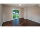 This bedroom features hardwood floors, neutral walls, a sliding glass door and backyard view at 102 Peaceful Vw, Acworth, GA 30102