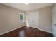 This bedroom features a double door closet, hardwood floors, neutral walls, and a bright window view at 102 Peaceful Vw, Acworth, GA 30102