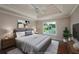 Staged bedroom with tray ceilings, a ceiling fan, and a large window for natural light at 102 Peaceful Vw, Acworth, GA 30102