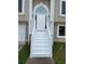 Charming front entrance featuring a bright white door, stairs, and manicured landscaping at 102 Peaceful Vw, Acworth, GA 30102