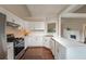 Well-lit kitchen with stainless steel appliances, white cabinets, and an attached breakfast bar at 102 Peaceful Vw, Acworth, GA 30102