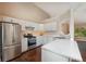 Modern kitchen with white cabinets, stainless steel appliances, and a breakfast bar at 102 Peaceful Vw, Acworth, GA 30102