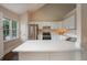 Bright kitchen with white cabinets, stainless steel appliances, and ample counter space at 102 Peaceful Vw, Acworth, GA 30102