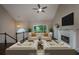 Cozy living room with fireplace, ceiling fan, and serene view of the outdoors at 102 Peaceful Vw, Acworth, GA 30102