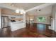 Open-concept kitchen and living room with hardwood floors, fireplace, and large windows at 102 Peaceful Vw, Acworth, GA 30102