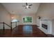 Bright living room with hardwood floors, fireplace, and large windows offering natural light and neighborhood views at 102 Peaceful Vw, Acworth, GA 30102