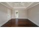 Main bedroom showcasing tray ceiling, hardwood floors, and access to the bathroom at 102 Peaceful Vw, Acworth, GA 30102