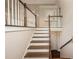 Elegant staircase with wooden steps and white railings leading to the upper level at 102 Peaceful Vw, Acworth, GA 30102