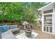 Backyard deck with grill, comfortable seating, and a view of the greenery at 111 Jeffrey Pl, Smyrna, GA 30082