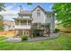 Home's backyard featuring a deck, patio, and lush green lawn at 111 Jeffrey Pl, Smyrna, GA 30082