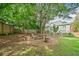Backyard featuring a fire pit with a circle of logs around the outside, enclosed by a wooden fence at 111 Jeffrey Pl, Smyrna, GA 30082