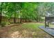 Expansive backyard with green lawn, mature trees, and a wooden fence at 111 Jeffrey Pl, Smyrna, GA 30082