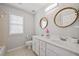 Bathroom featuring double sinks, tile floor, and ample lighting at 111 Jeffrey Pl, Smyrna, GA 30082