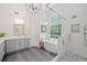 Bright bathroom with a modern design featuring a frameless shower, soaking tub, and gray vanity at 111 Jeffrey Pl, Smyrna, GA 30082