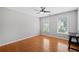 Bright bedroom with hardwood floors, two windows, and a dark table at 111 Jeffrey Pl, Smyrna, GA 30082