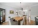 Dining area has chair rail, hardwood floors, and a modern light fixture at 111 Jeffrey Pl, Smyrna, GA 30082