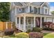 Inviting front porch with white columns, charming landscaping, and decorative arbor at 111 Jeffrey Pl, Smyrna, GA 30082