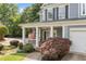 Charming home featuring a covered porch, an American flag, and lush landscaping at 111 Jeffrey Pl, Smyrna, GA 30082