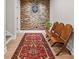 Hallway with stone accent wall, dartboard and red accent rug at 111 Jeffrey Pl, Smyrna, GA 30082