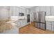 Bright kitchen features white cabinets, stainless steel appliances, and light granite countertops at 111 Jeffrey Pl, Smyrna, GA 30082