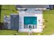 Aerial view of a backyard featuring a pool, spa, patio, outdoor kitchen, and manicured lawn at 2400 Worth Ave, Loganville, GA 30052