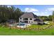 Beautiful backyard featuring a sparkling pool, cabana, and lush landscaping on a sunny day at 2400 Worth Ave, Loganville, GA 30052