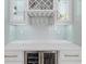Home wet bar with glass wine rack, beverage cooler and tile backsplash at 2400 Worth Ave, Loganville, GA 30052