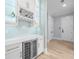 Modern bar area with white cabinets, a wine rack, and a beverage refrigerator at 2400 Worth Ave, Loganville, GA 30052