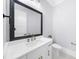 Bathroom vanity with marble countertop, bronze fixtures, and decorative mirror at 2400 Worth Ave, Loganville, GA 30052
