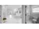 Large bathroom with lots of light, dual sinks, a soaking tub, and white tile floors at 2400 Worth Ave, Loganville, GA 30052