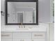 Bathroom sink with white cabinets, gold hardware, and a large mirror at 2400 Worth Ave, Loganville, GA 30052