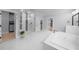 Bright bathroom with a glass shower, soaking tub, dual vanities, and washer dryer at 2400 Worth Ave, Loganville, GA 30052