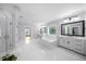 Large and bright bathroom with a soaking tub, a glass shower and dual vanities at 2400 Worth Ave, Loganville, GA 30052