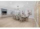 Open dining area with a large table, stylish chandelier and fireplace at 2400 Worth Ave, Loganville, GA 30052