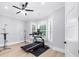 Bright exercise room with treadmill, ceiling fan, and natural light from the windows at 2400 Worth Ave, Loganville, GA 30052