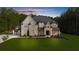 Beautiful two-story home featuring a well-manicured lawn and a blend of stone and painted brick at 2400 Worth Ave, Loganville, GA 30052