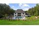 Expansive home exterior showcasing a backyard pool, outdoor kitchen, and beautiful landscaping at 2400 Worth Ave, Loganville, GA 30052
