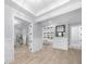 Bright foyer features light wood floors, decorative walls and a glass display cabinet in the background at 2400 Worth Ave, Loganville, GA 30052
