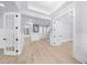 Bright foyer features light wood floors, open doors and a pool visible through the window at 2400 Worth Ave, Loganville, GA 30052