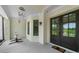 Front porch with double doors, brick columns, and stylish decor, offering a welcoming entrance to the home at 2400 Worth Ave, Loganville, GA 30052