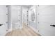 Clean hallway with white doors, light hardwood floors, and modern decor at 2400 Worth Ave, Loganville, GA 30052