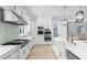 Modern kitchen with white cabinets, stainless steel appliances, and an island at 2400 Worth Ave, Loganville, GA 30052