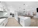 Spacious kitchen with a large island, stainless steel appliances, and light wood flooring at 2400 Worth Ave, Loganville, GA 30052